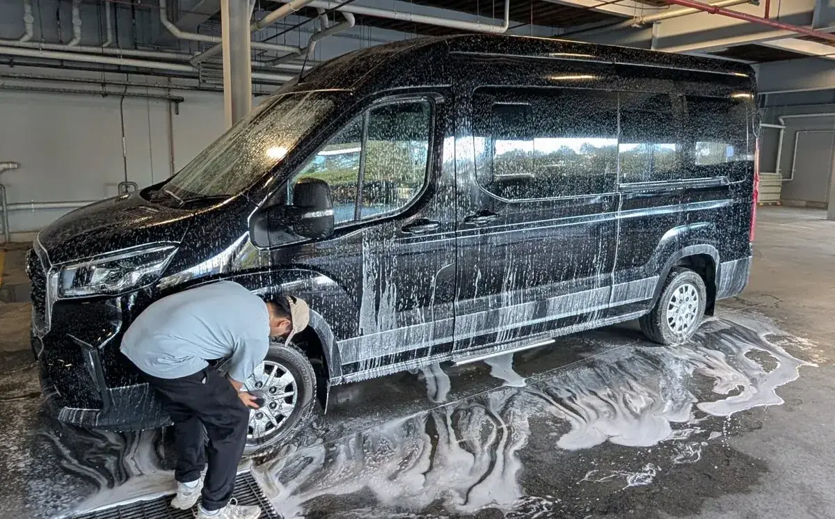Black van being washed on site by Luxe Mobile Car Spa, commercial vehicle detailing in Sydney