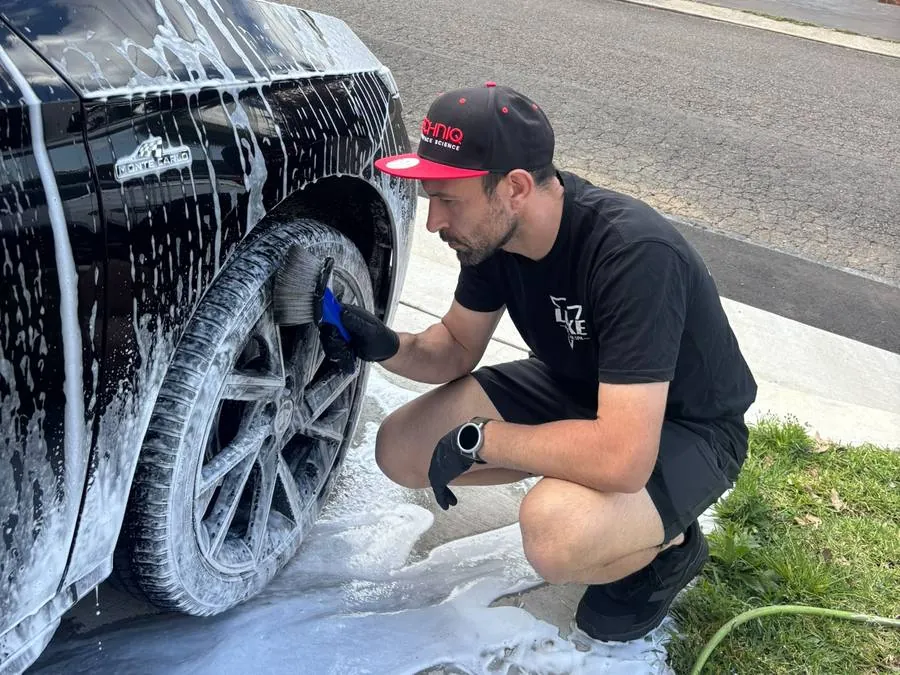 Daniel cleaning a wheel on a customer's car in Sydney